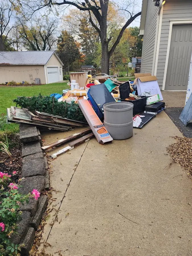 Dumpster being loaded with debris for 12 Yard Dumpster Rental in Destrehan